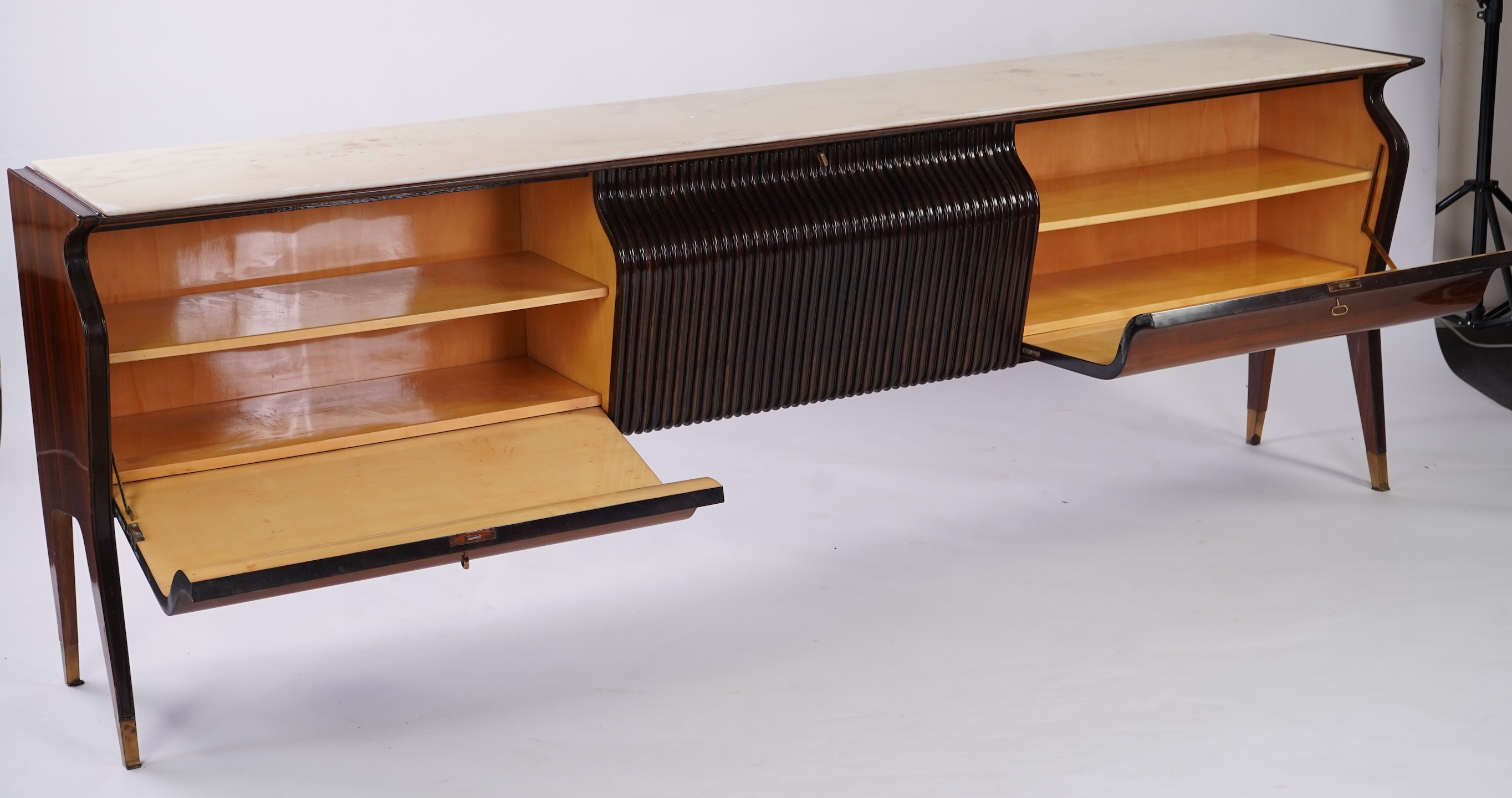 Osvaldo Borsani (Italian, 1911-1985) for Atelier Borsani Varedo: A large Indian rosewood and mahogany credenza, 276.5cm wide x 49cm deep x 94cm high